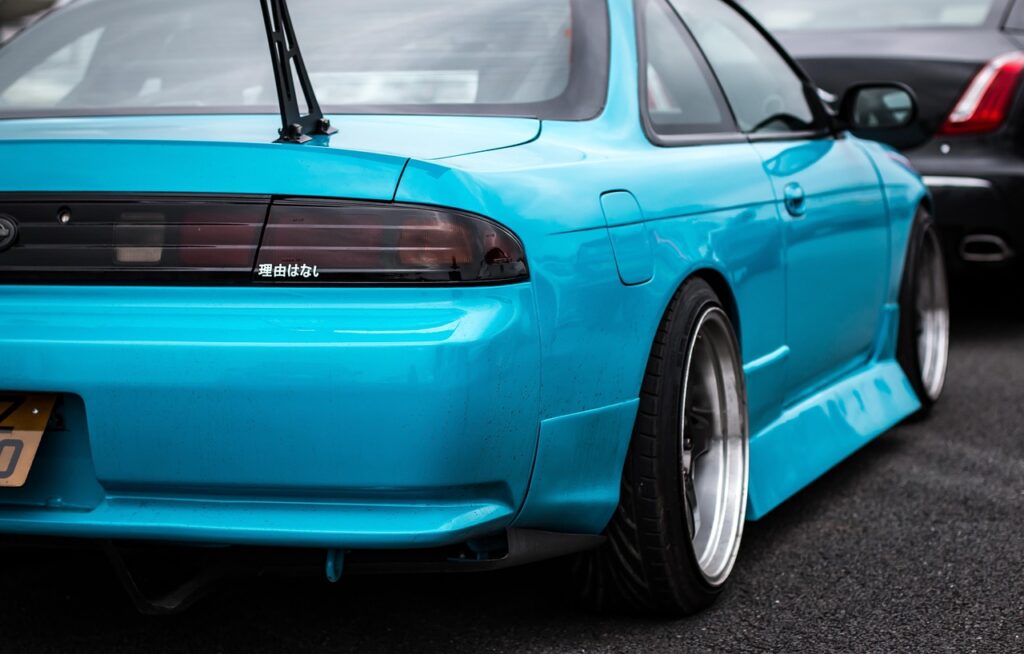 Nissan Silvia S14 parked on the road, showcasing its sleek design and sporty stance.