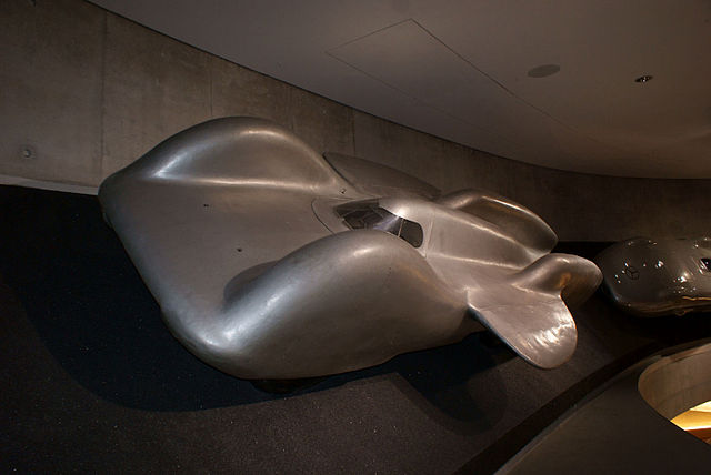 The Mercedes-Benz T80 on display at the Mercedes-Benz Museum in Stuttgart, showcasing its sleek aerodynamic design and six-wheel structure, originally built for a world land speed record attempt.