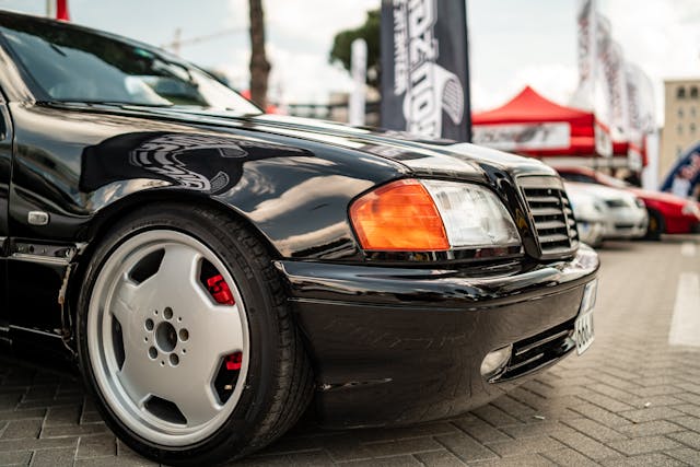 Front view of a sleek black Mercedes-Benz, showcasing its bold design and elegance.